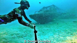 Speedboat wreck in Mabul Island, Malaysia by Daniel Douglas 